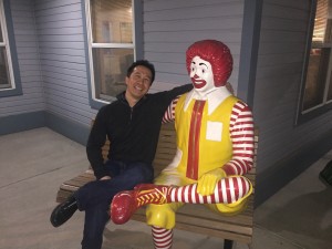 Edward Estipona sits with Ronald McDonald