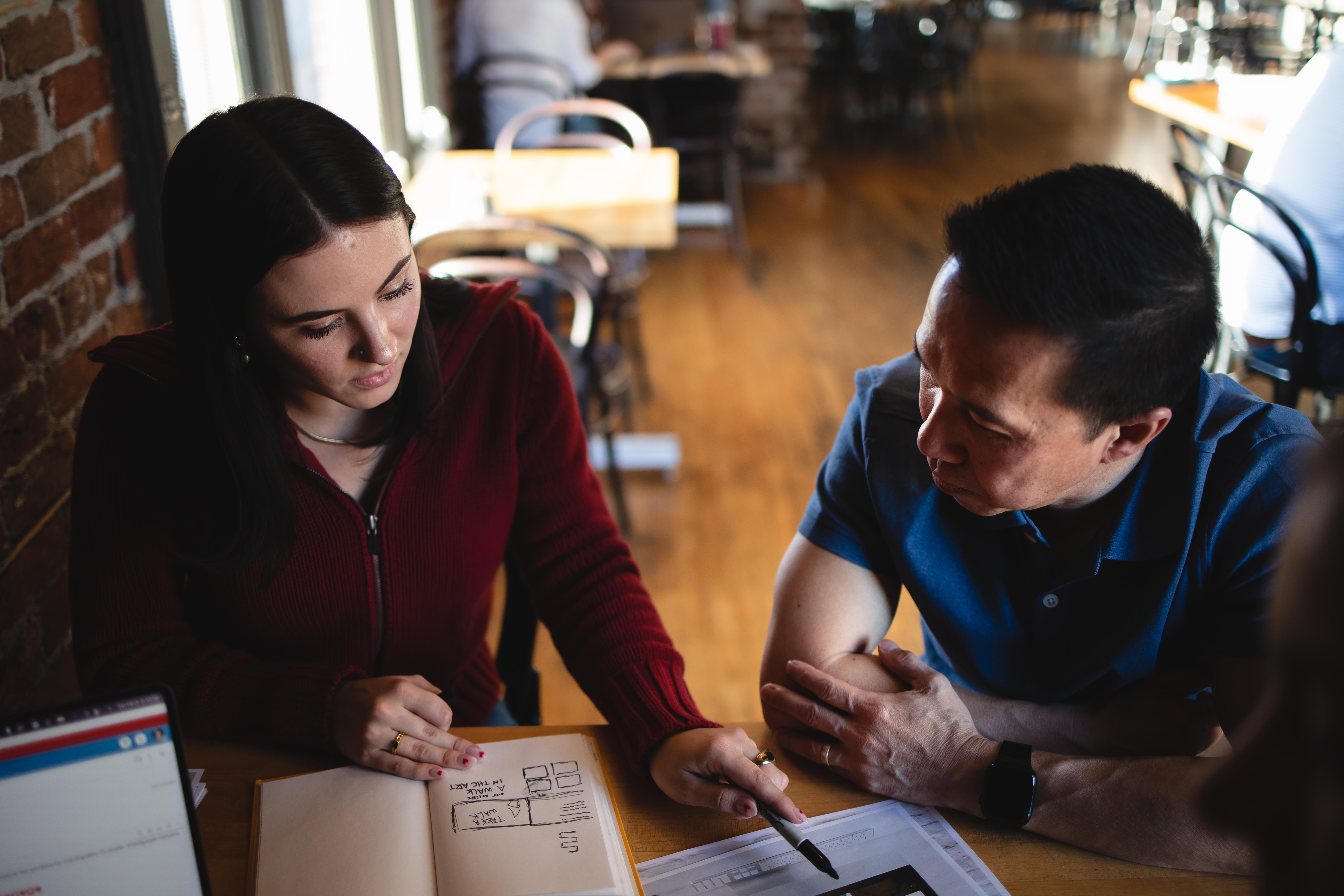 team members reviewing work at a table