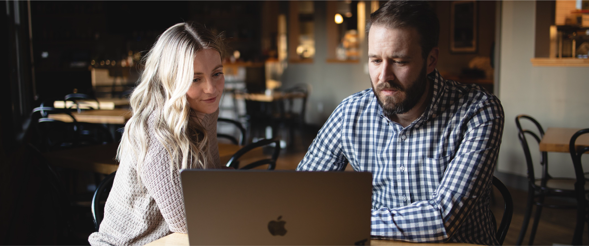 Chelsey and Kyle work on their laptop.