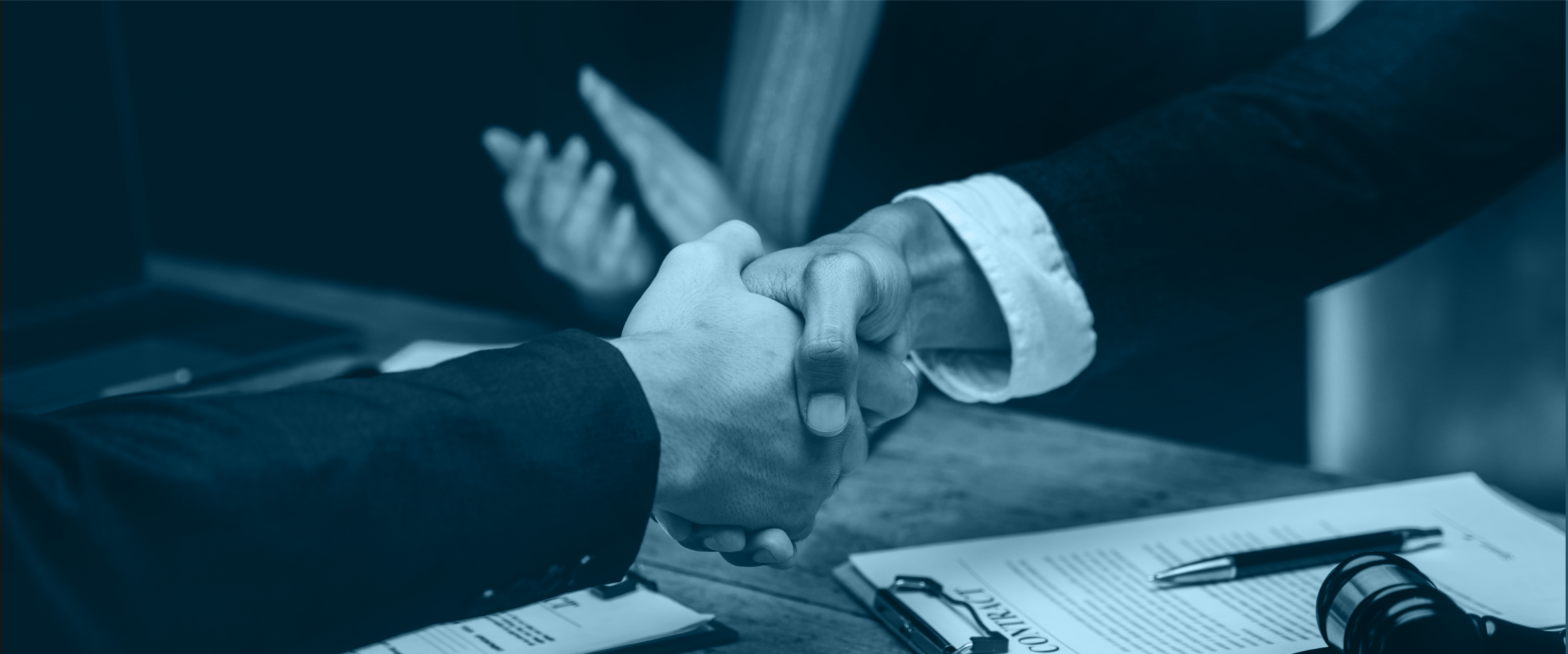 Photo of people shaking hands in a mediators office