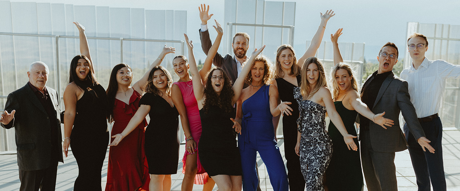 Estipona group team celebating together on the roof of an art museum