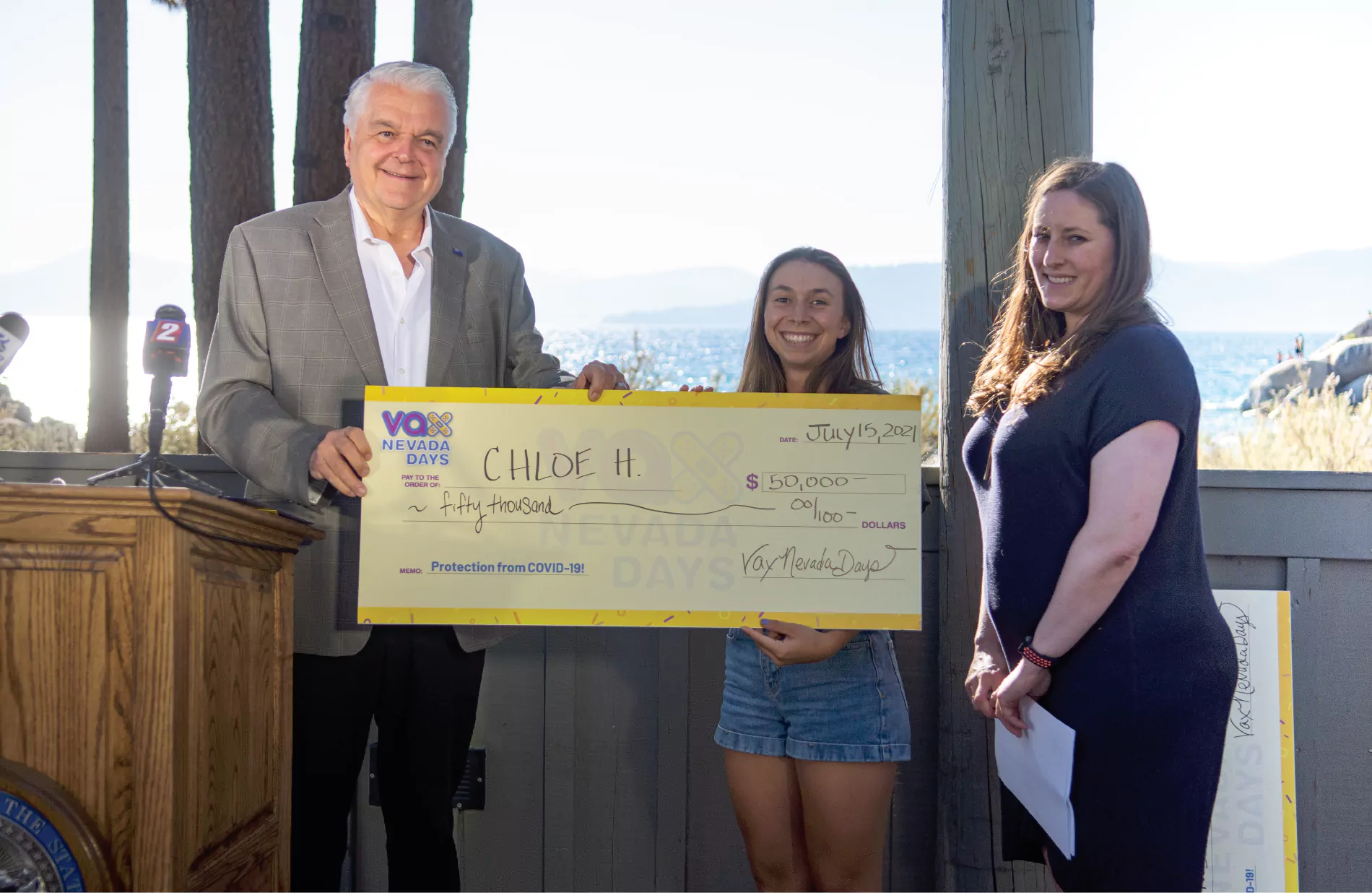 Governor Sisolak presenting Vax Nevada Days winner with check