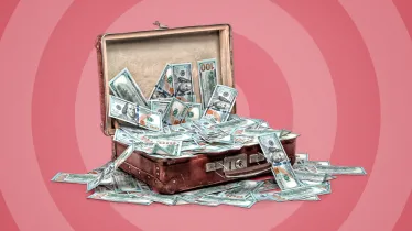 Red background with suitcase open in the foreground, money is spilling from the suitcase